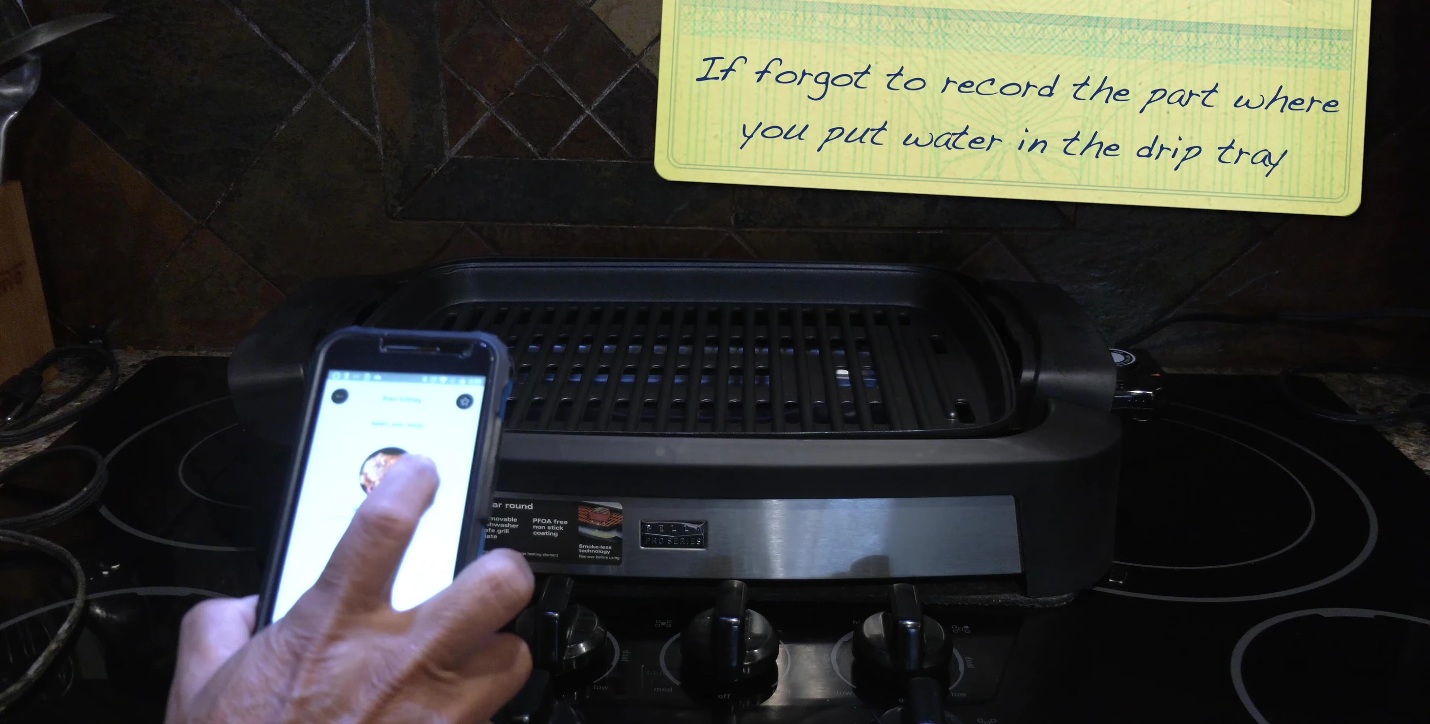 The grill heating up, showing the temperature control dial.