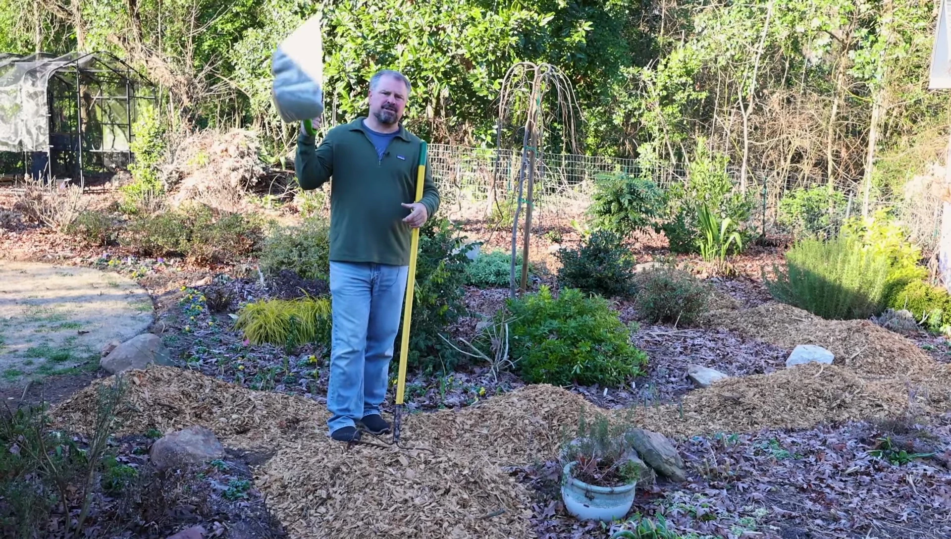 Using a snow shovel to spread wood chips