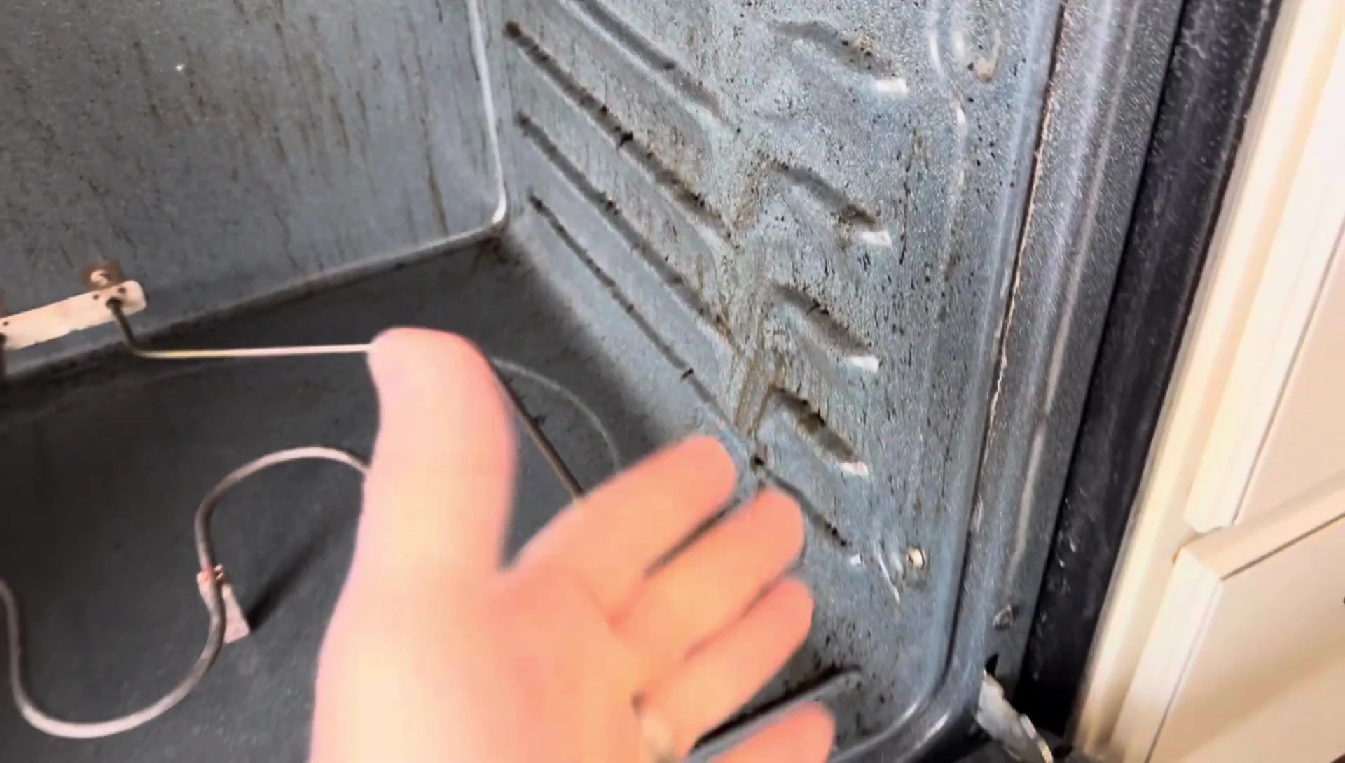 Cleaner dripping down the oven walls after application.