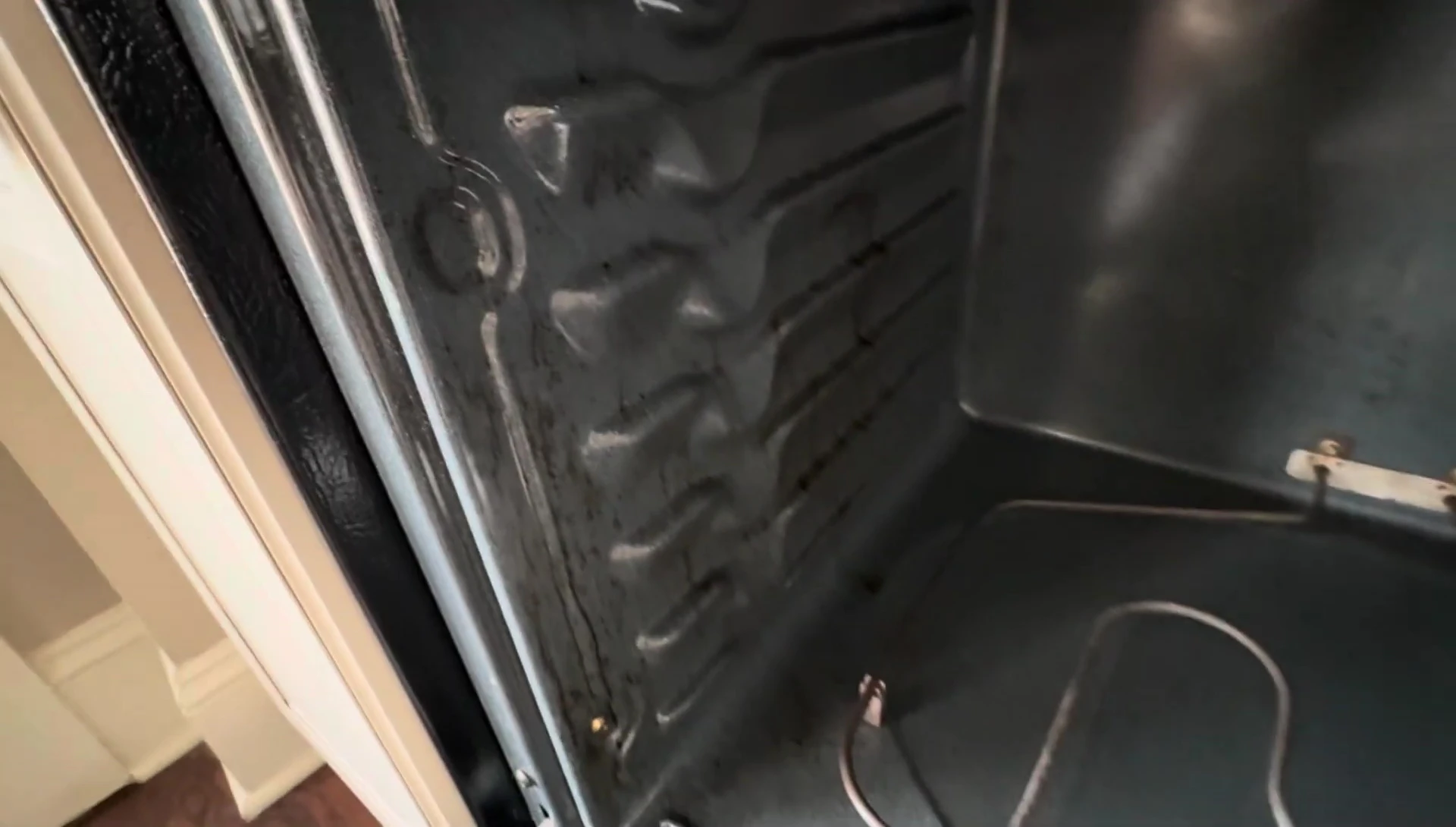 Oven interior with heat turned on to check for remaining grime.