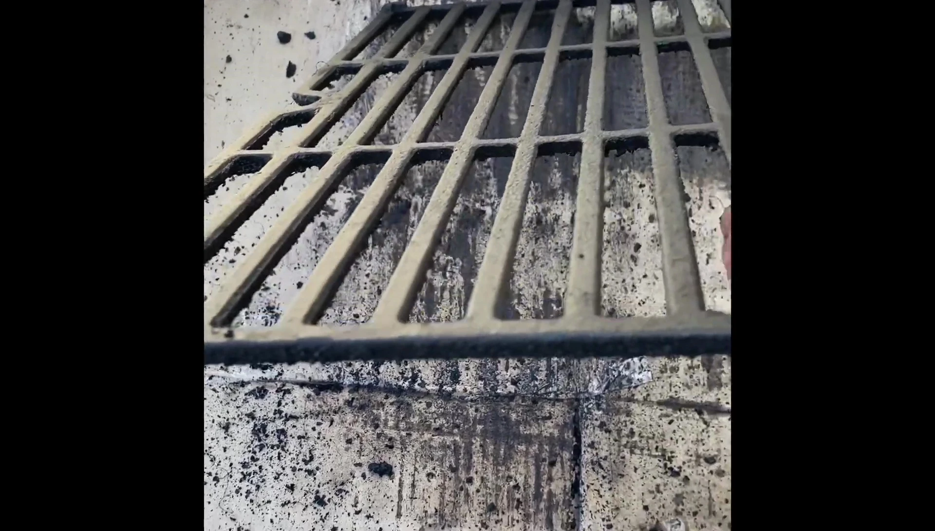 After cleaning: The grill grates are noticeably cleaner, with most of the grime removed.