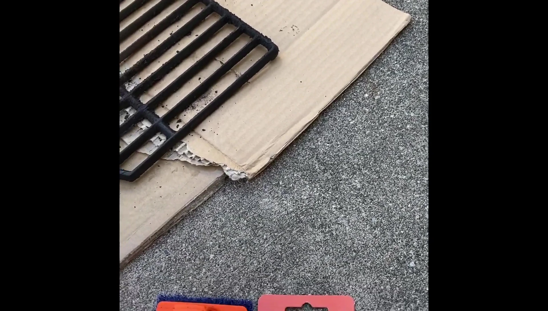 Spraying the Citrusafe cleaner onto the dirty grill grates.