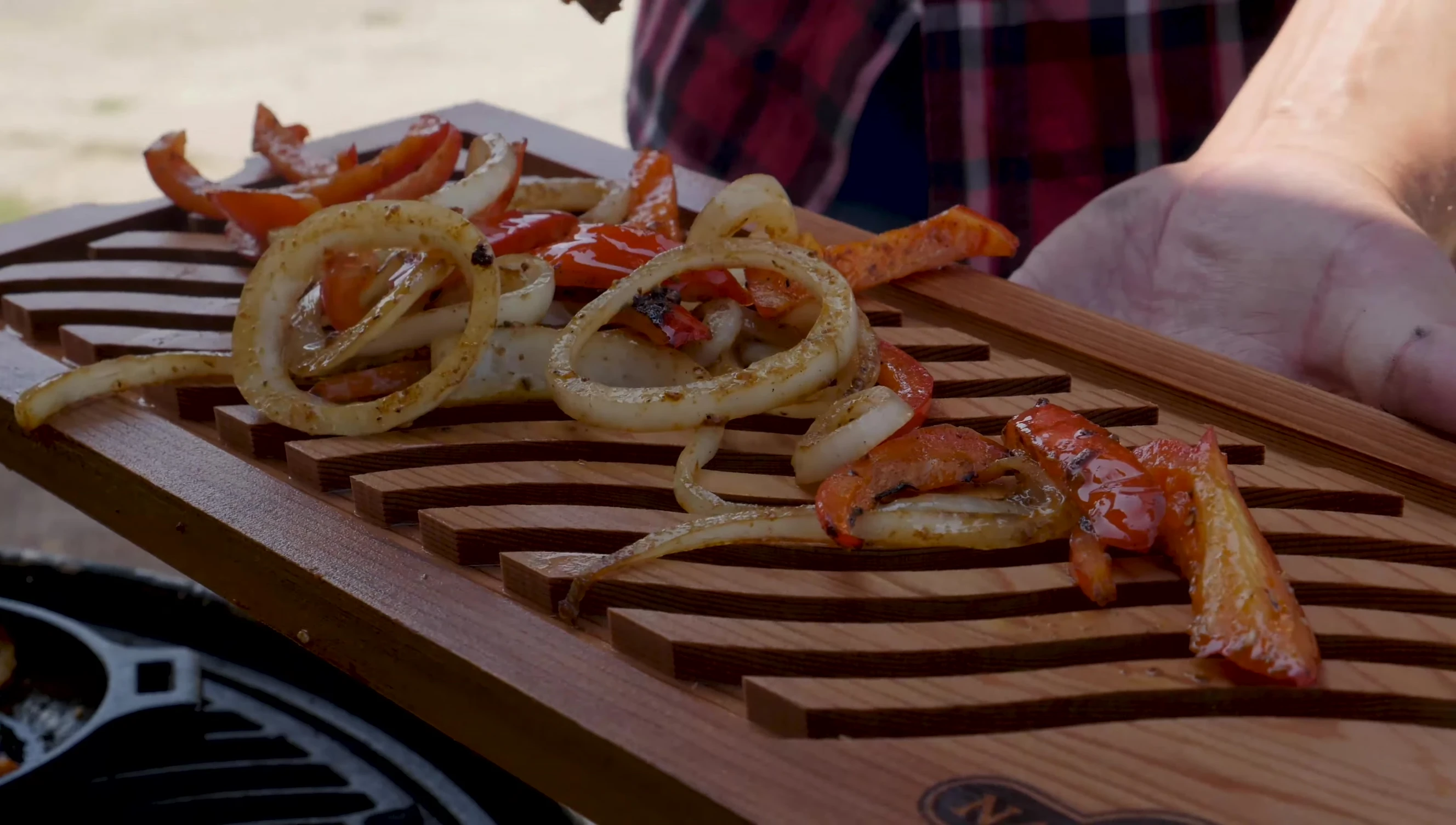 The infusion board placed on the grill, with ingredients arranged on it.