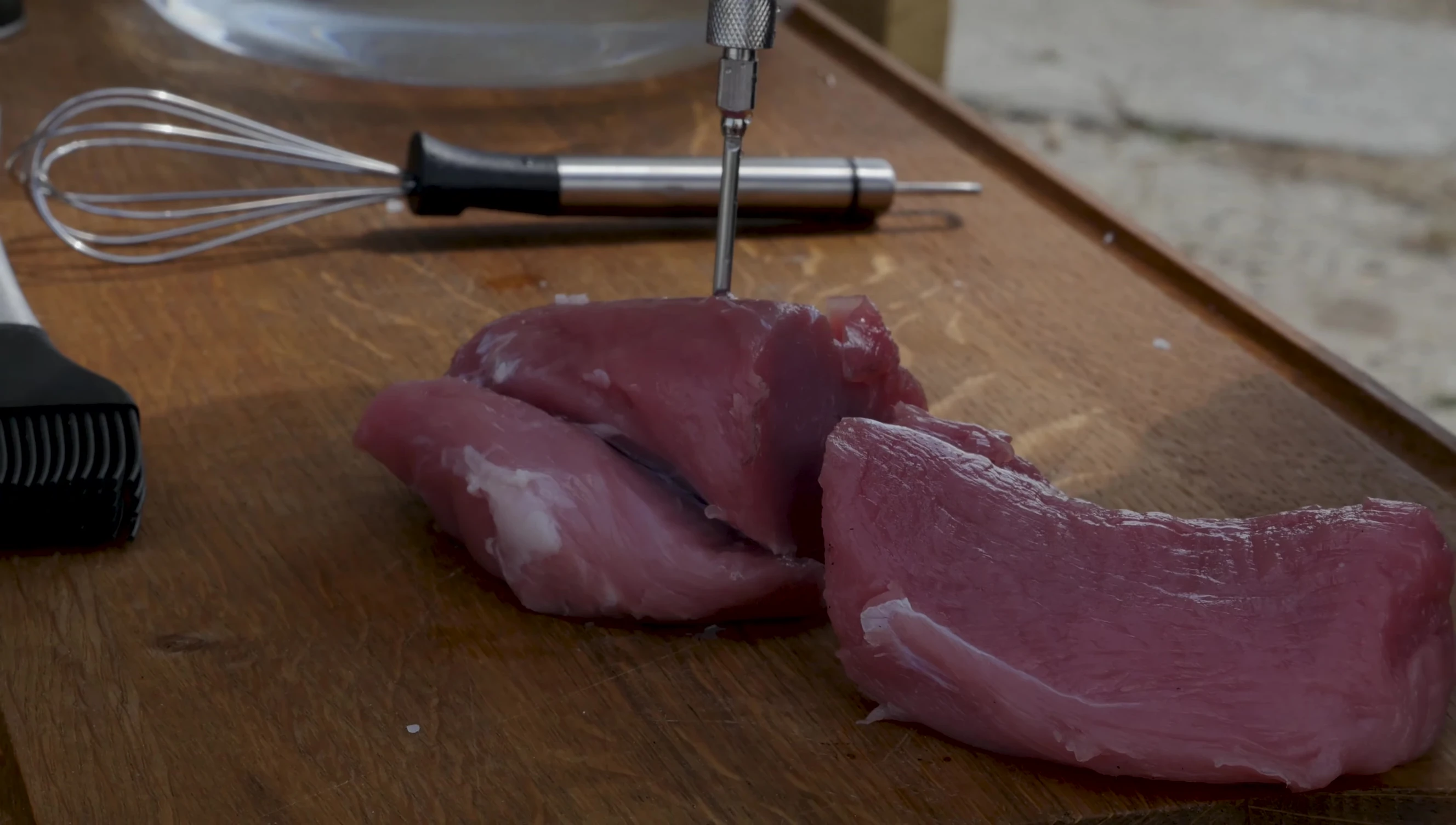 The injected pork loin, visibly plumped from the brine.
