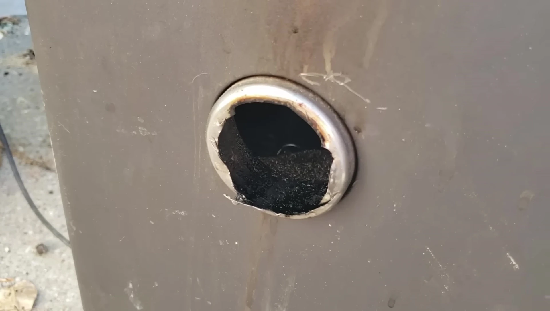 The smoker’s exhaust vent removed to enhance airflow.