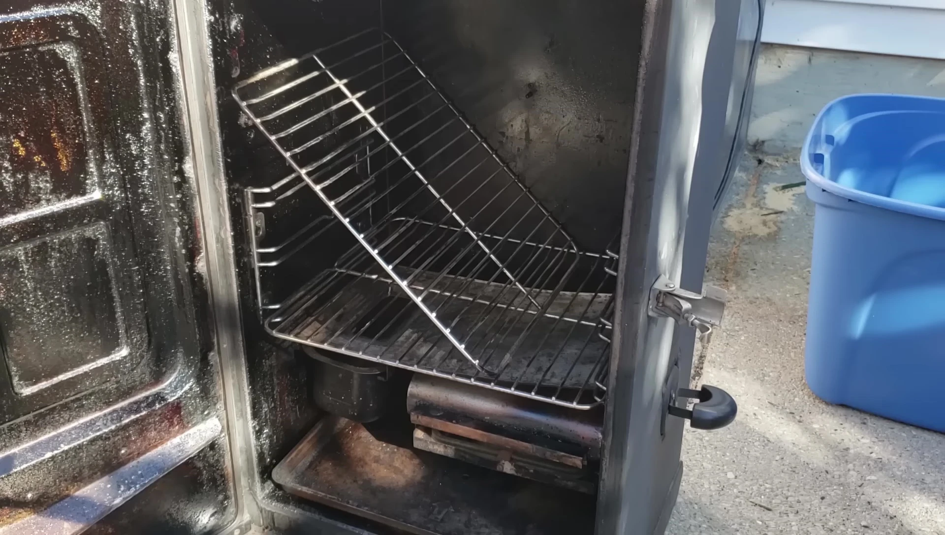 The brisket being positioned within the modified smoker.
