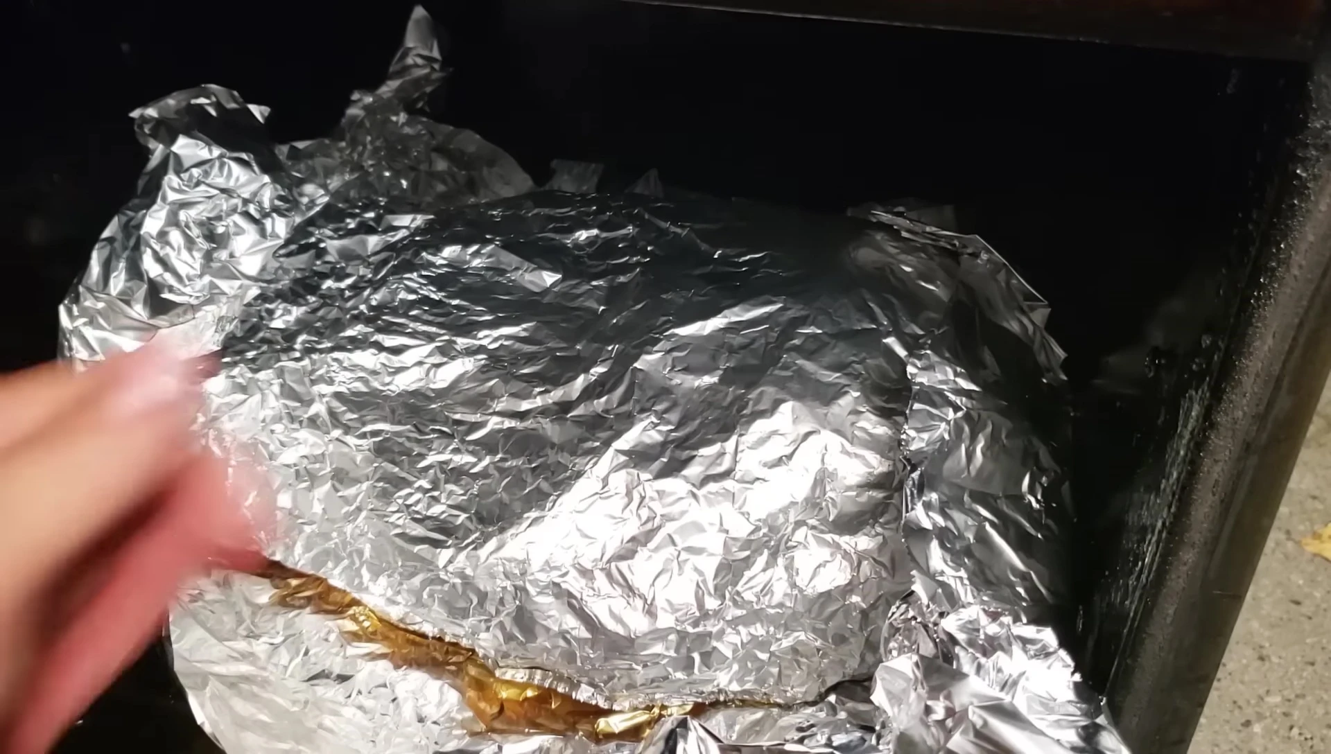The presenter demonstrating the proper technique for testing brisket tenderness.