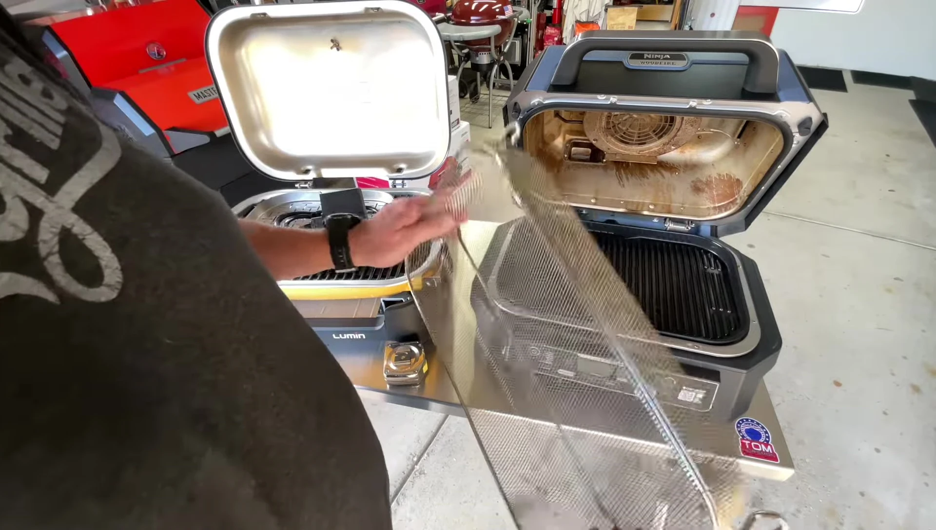 Inside view of the Ninja Woodfire grill, showing the cooking surface and basket.
