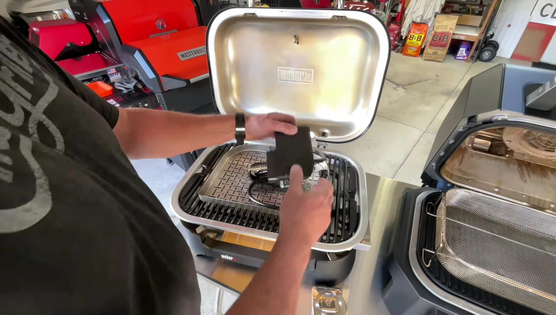 Inside view of the Weber Lumin grill, showing the cooking surface and steamer basket.