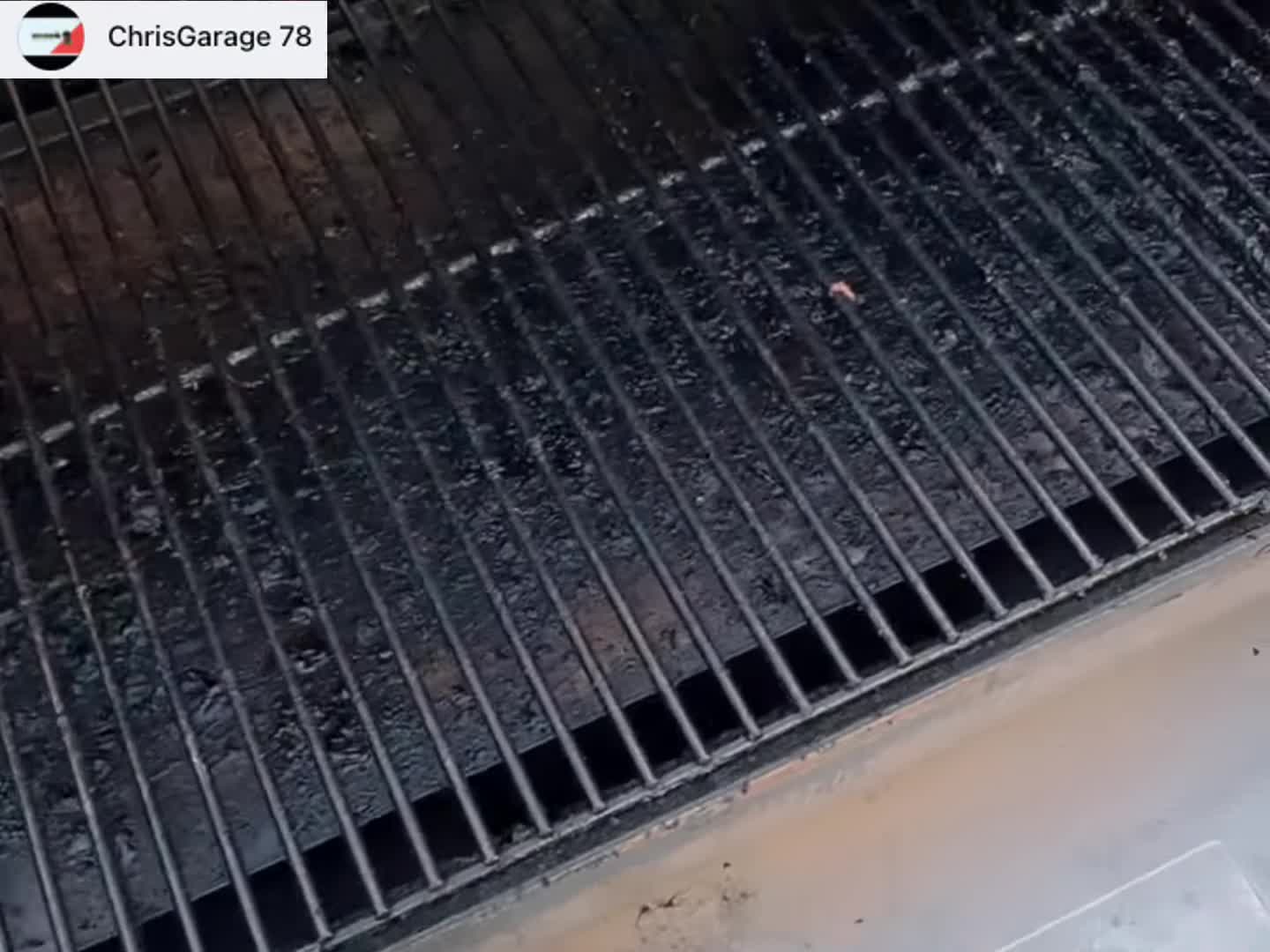 Close-up of a dirty grill grate before cleaning.