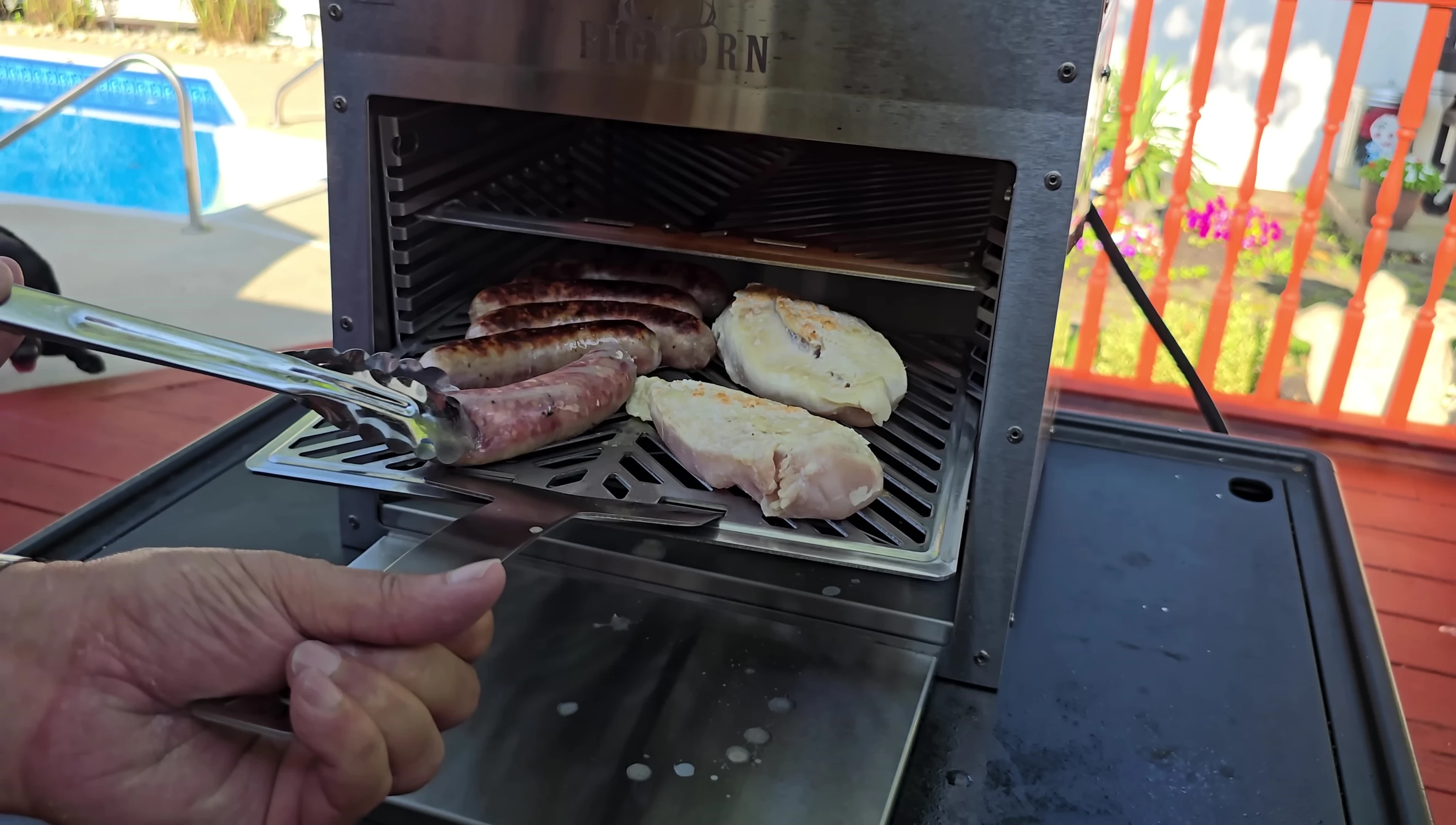 Close up shot of sausages during cooking showing the char marks and juices.