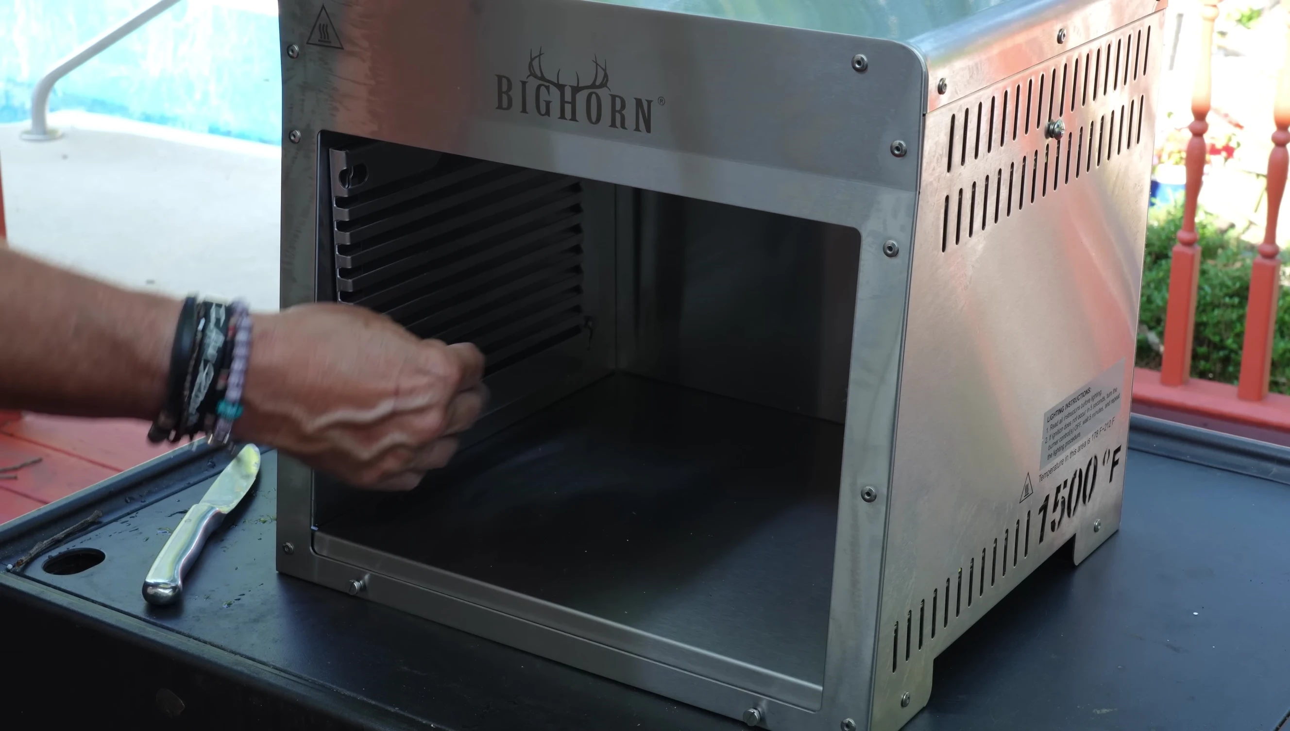 Shot showcasing the multiple levels and side rails of the grill, emphasizing its versatility.