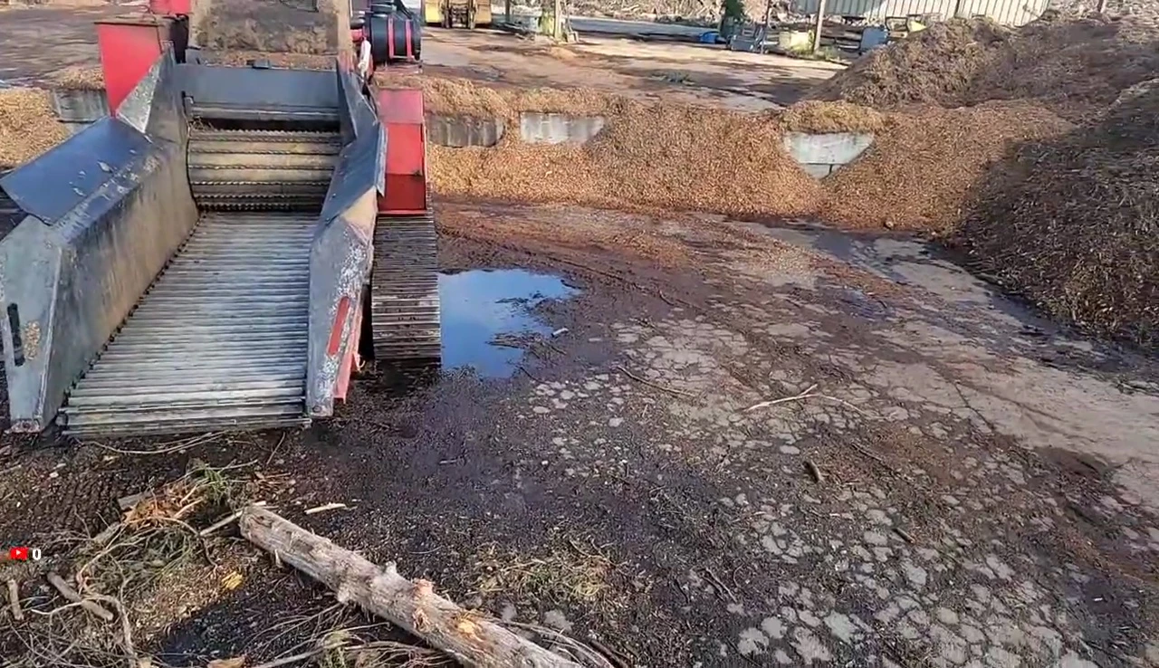 The logger checking the wood chipper in the early morning.