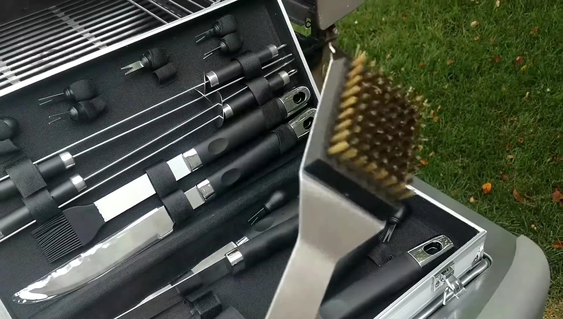 Close-up of the grill scraper and brush.