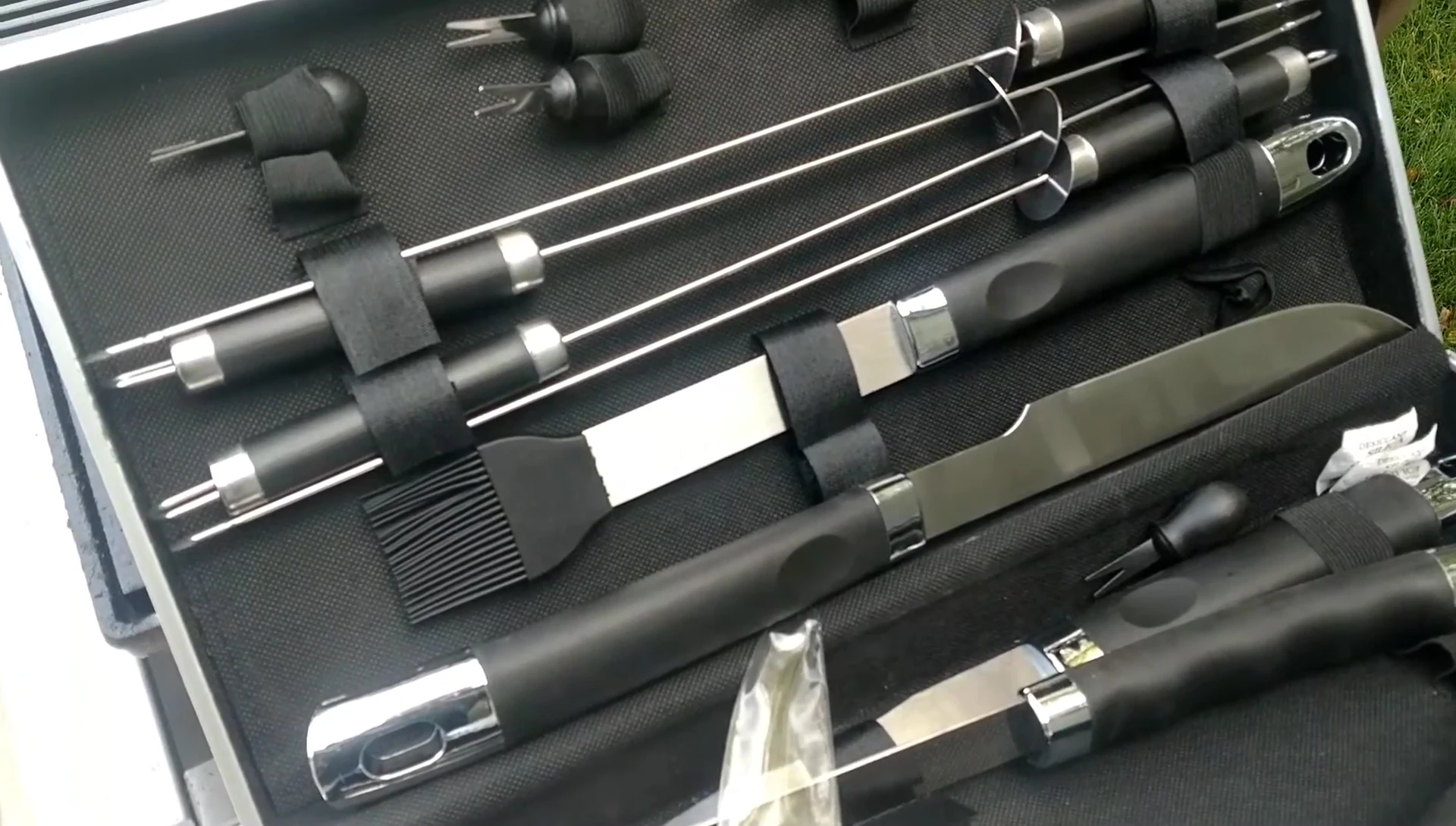 The reviewer shows the skewers and corn holders.