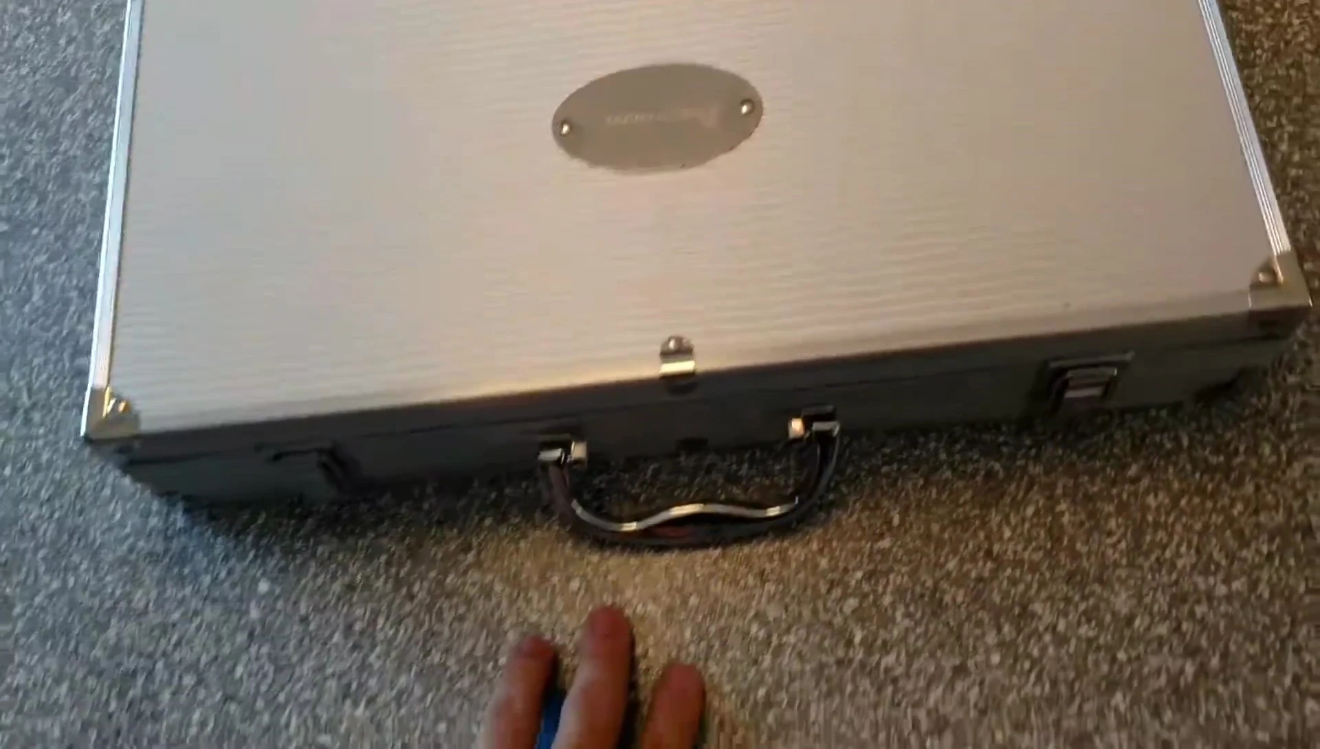 The reviewer holding the closed grill set case, highlighting its size and sturdiness.