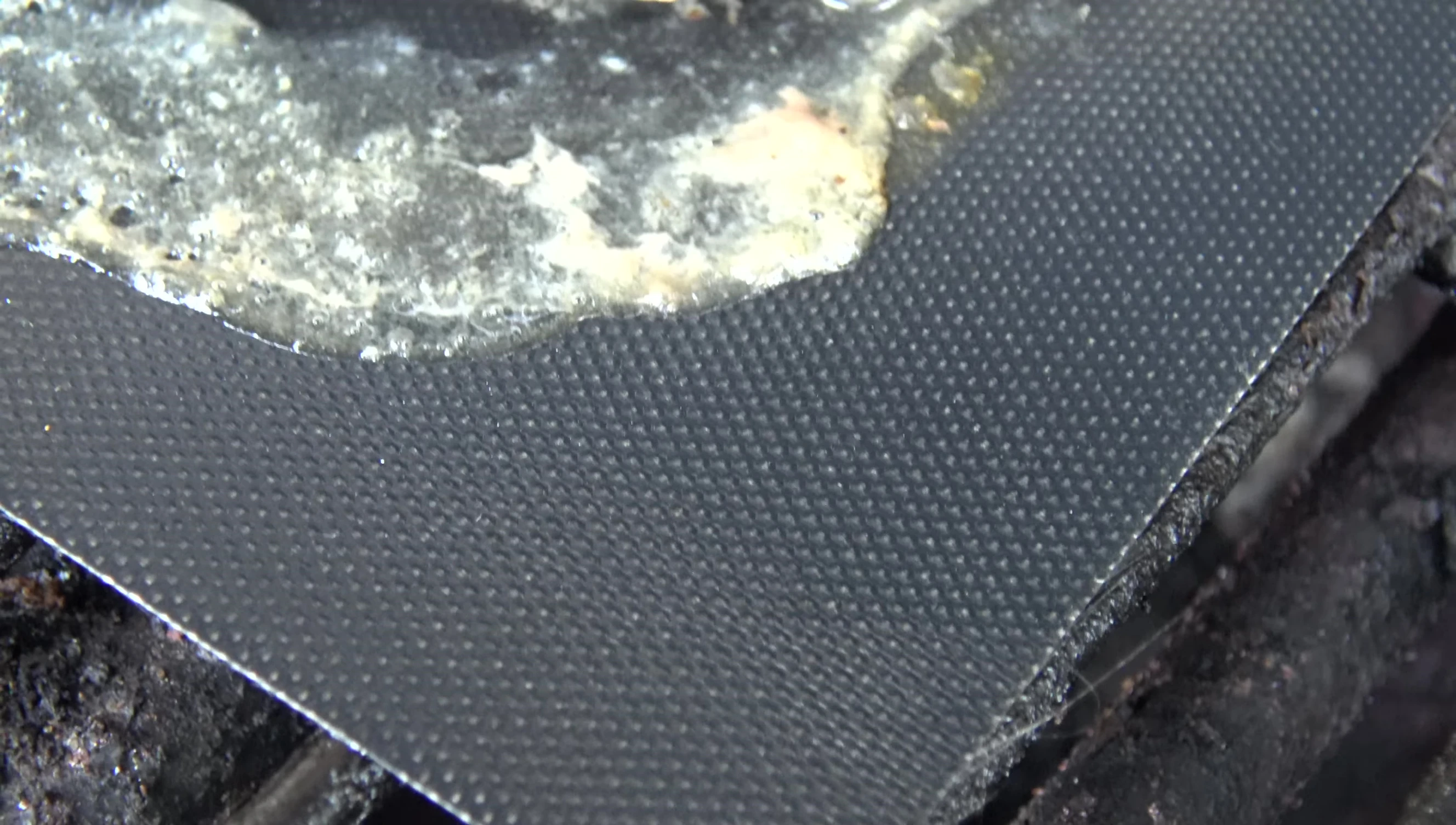 Close-up shot highlighting the fiberglass weave structure of the mat.
