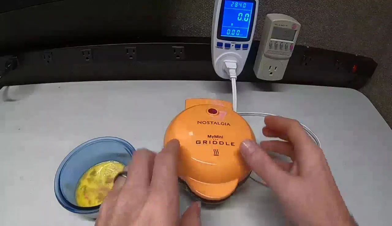 The griddle heating up and emitting a clicking sound.