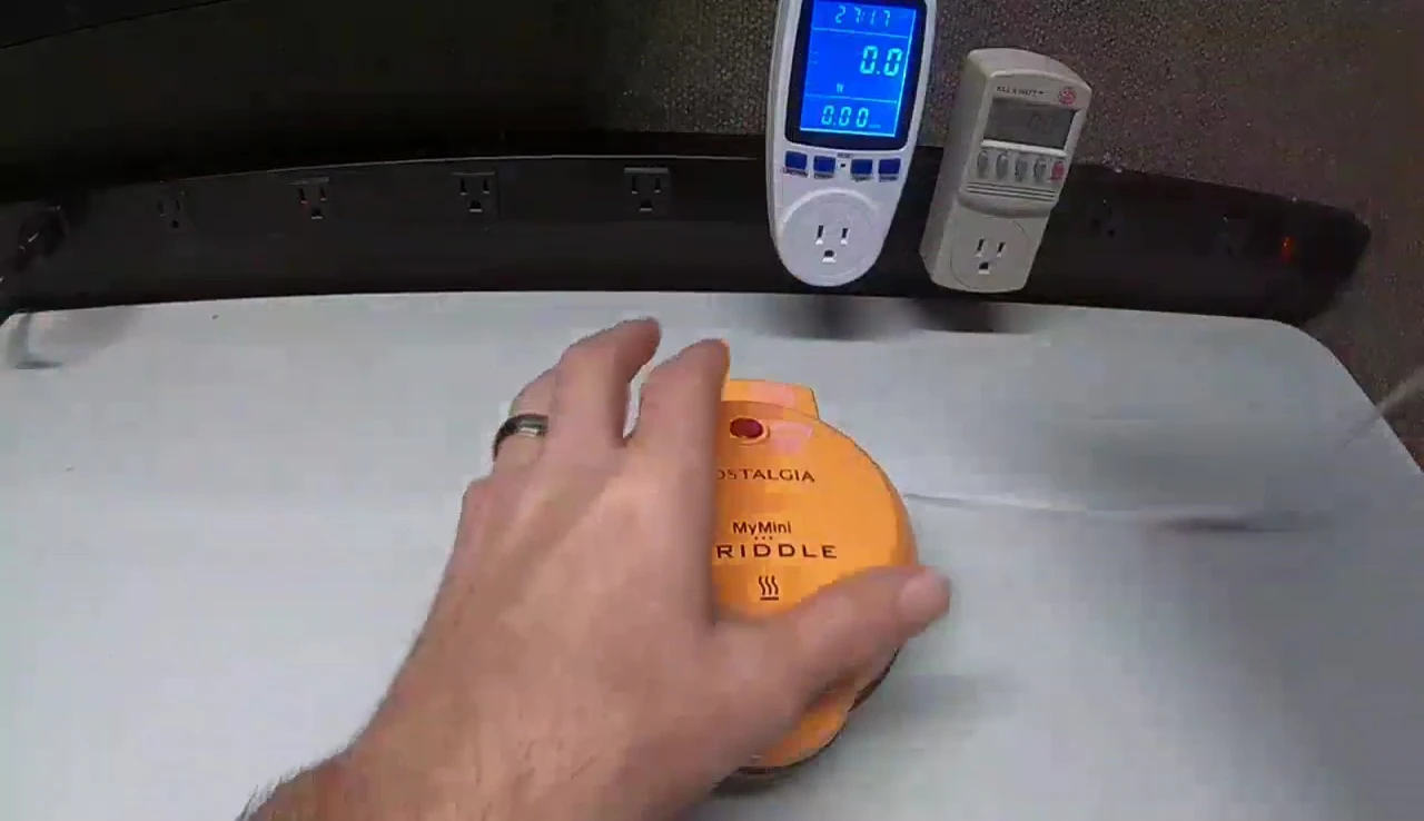 Close-up of the MyMini griddle being plugged into a power source.