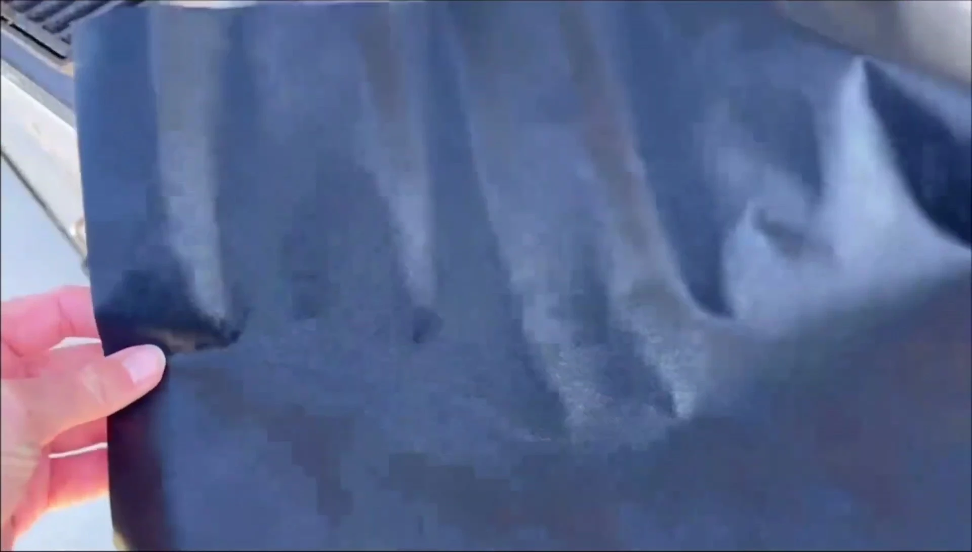 The grill mat showing its effectiveness in catching food debris