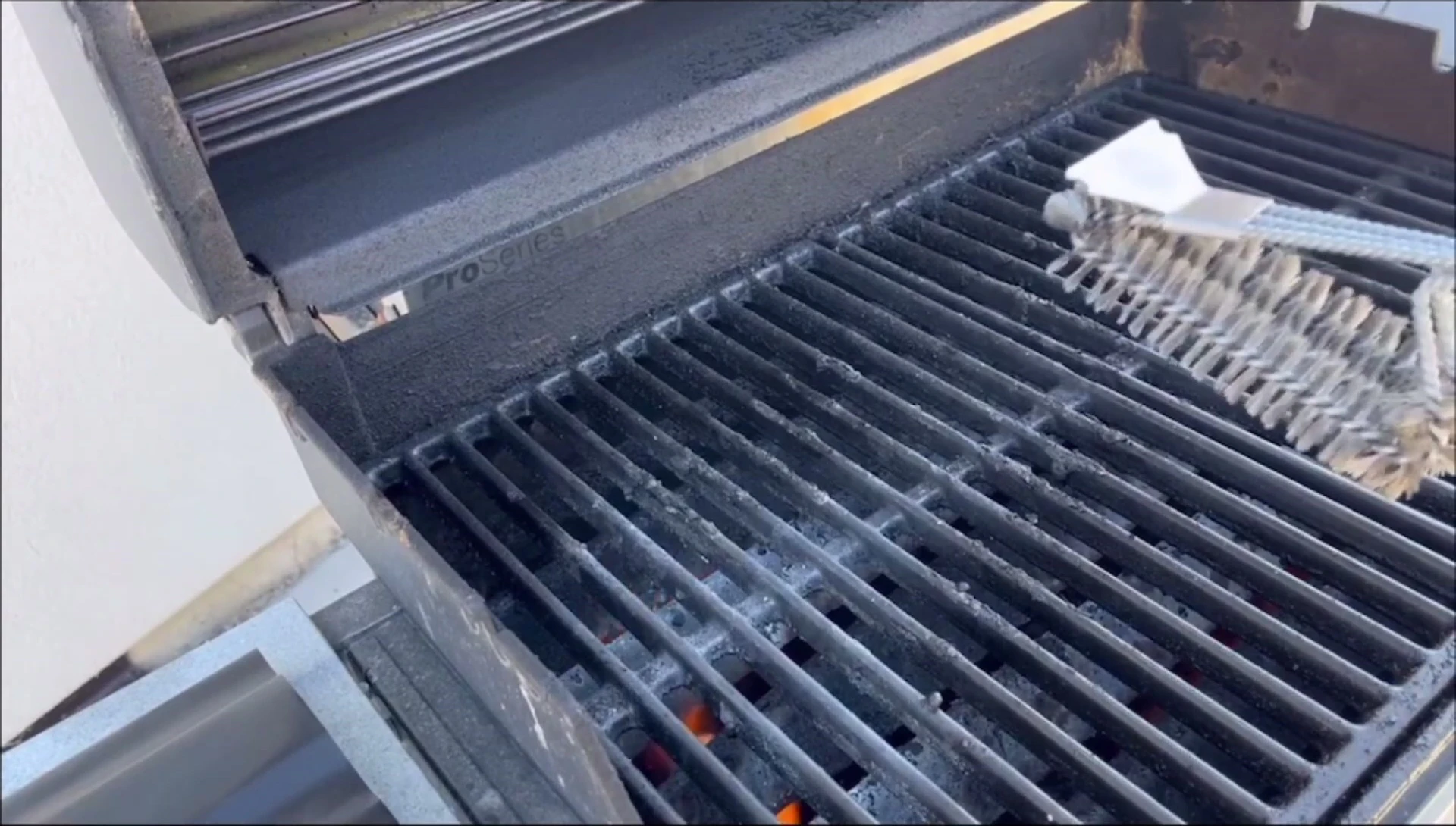 The grill brush in action, easily removing debris.