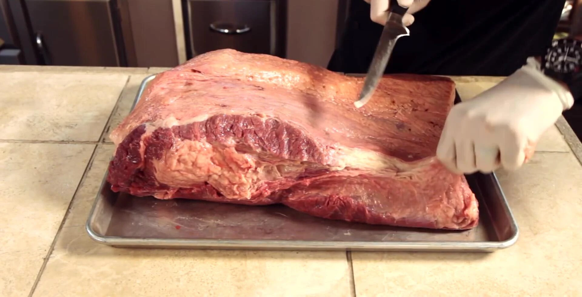 Trimming the fat from a 16-pound brisket.