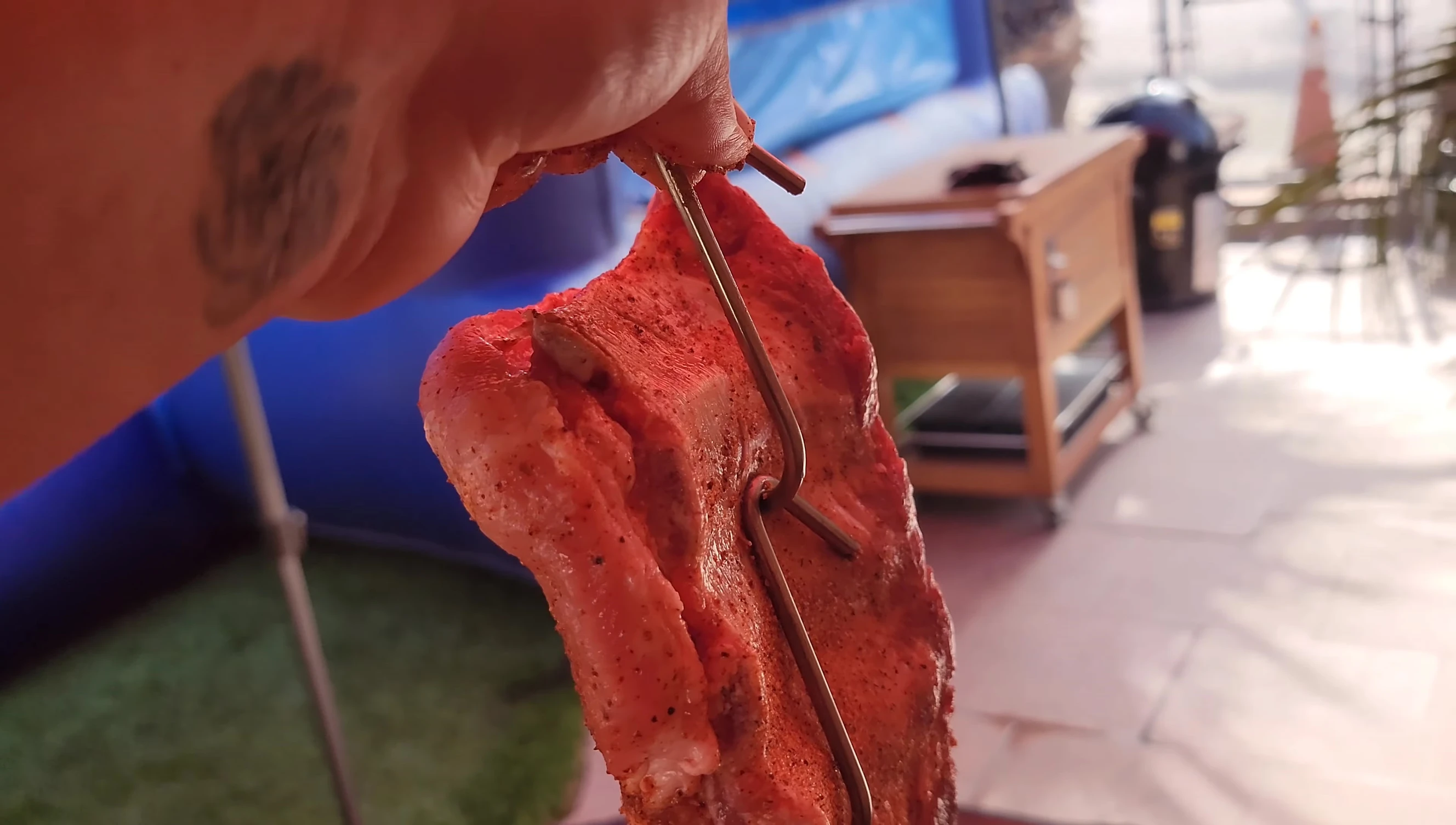 Close-up of the double hooking technique on a meaty rib