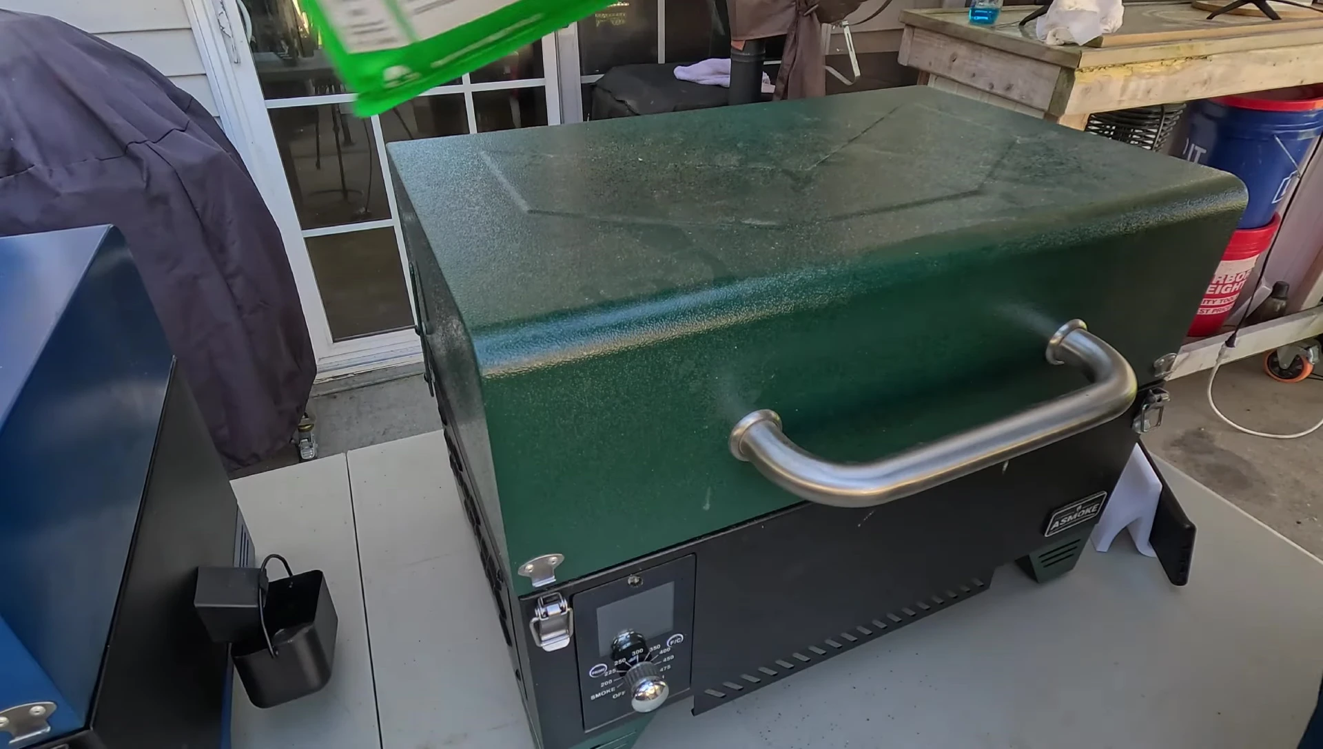 The AS350 grill hopper being filled with apple pellets.