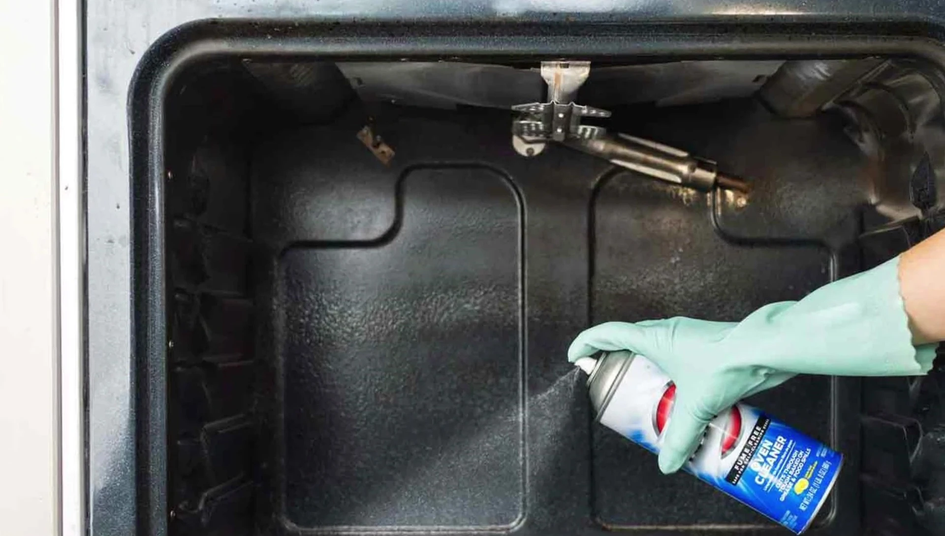 Demonstration of applying oven cleaner inside an oven.