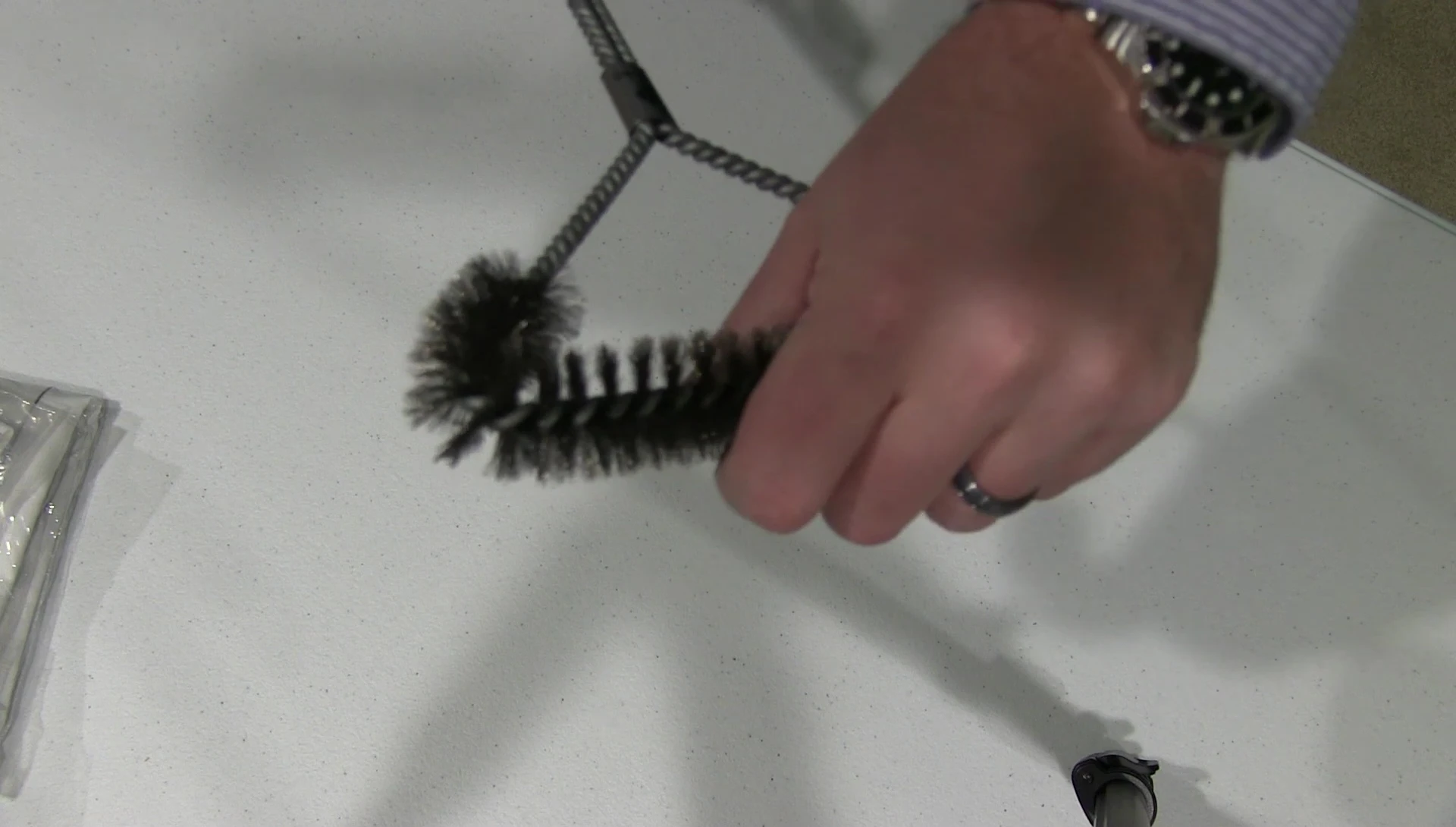 Close-up of the Weber grill brush bristles, highlighting their thickness and sturdiness.