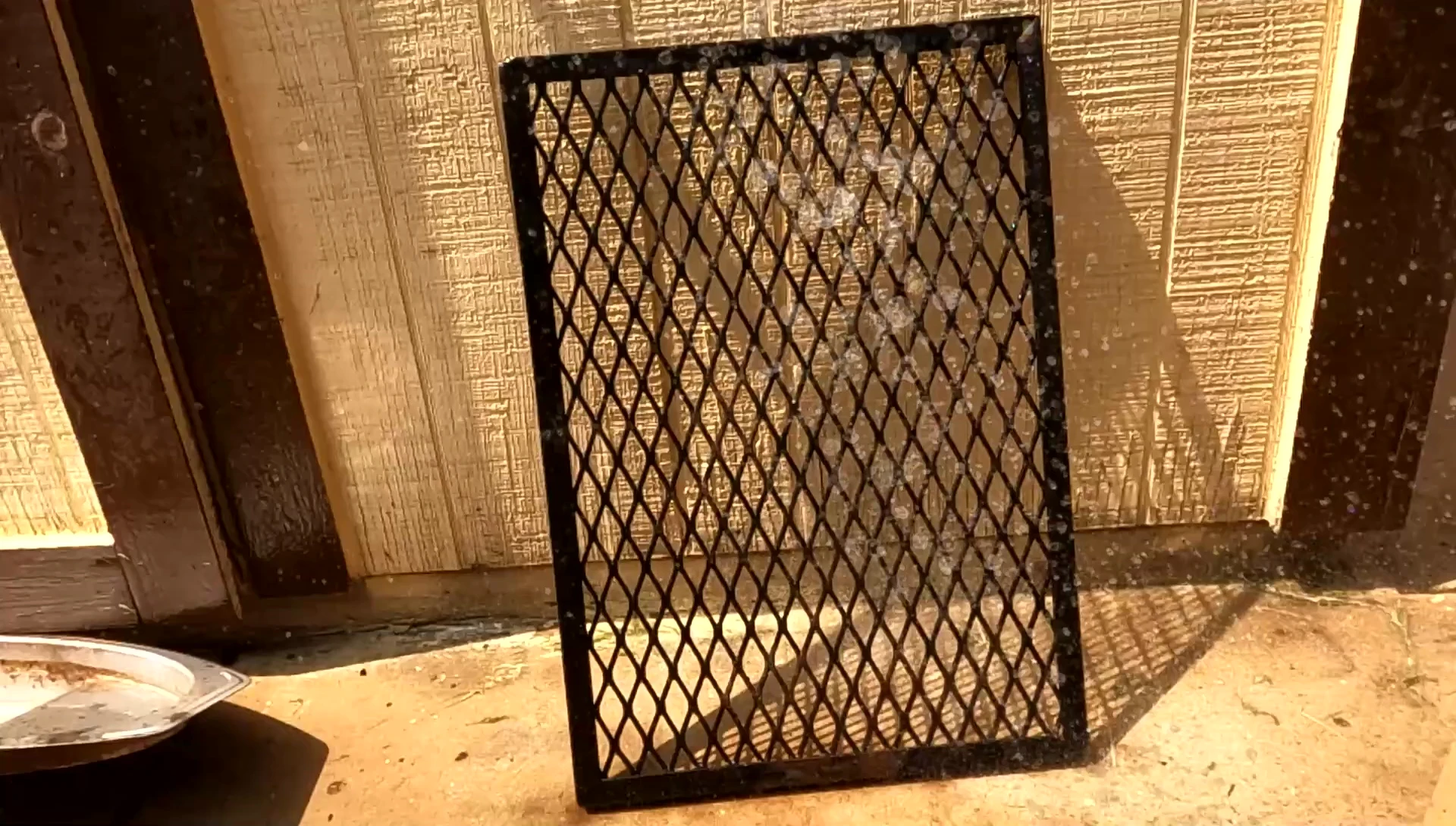 Close up of grease running off the grate onto the ground.