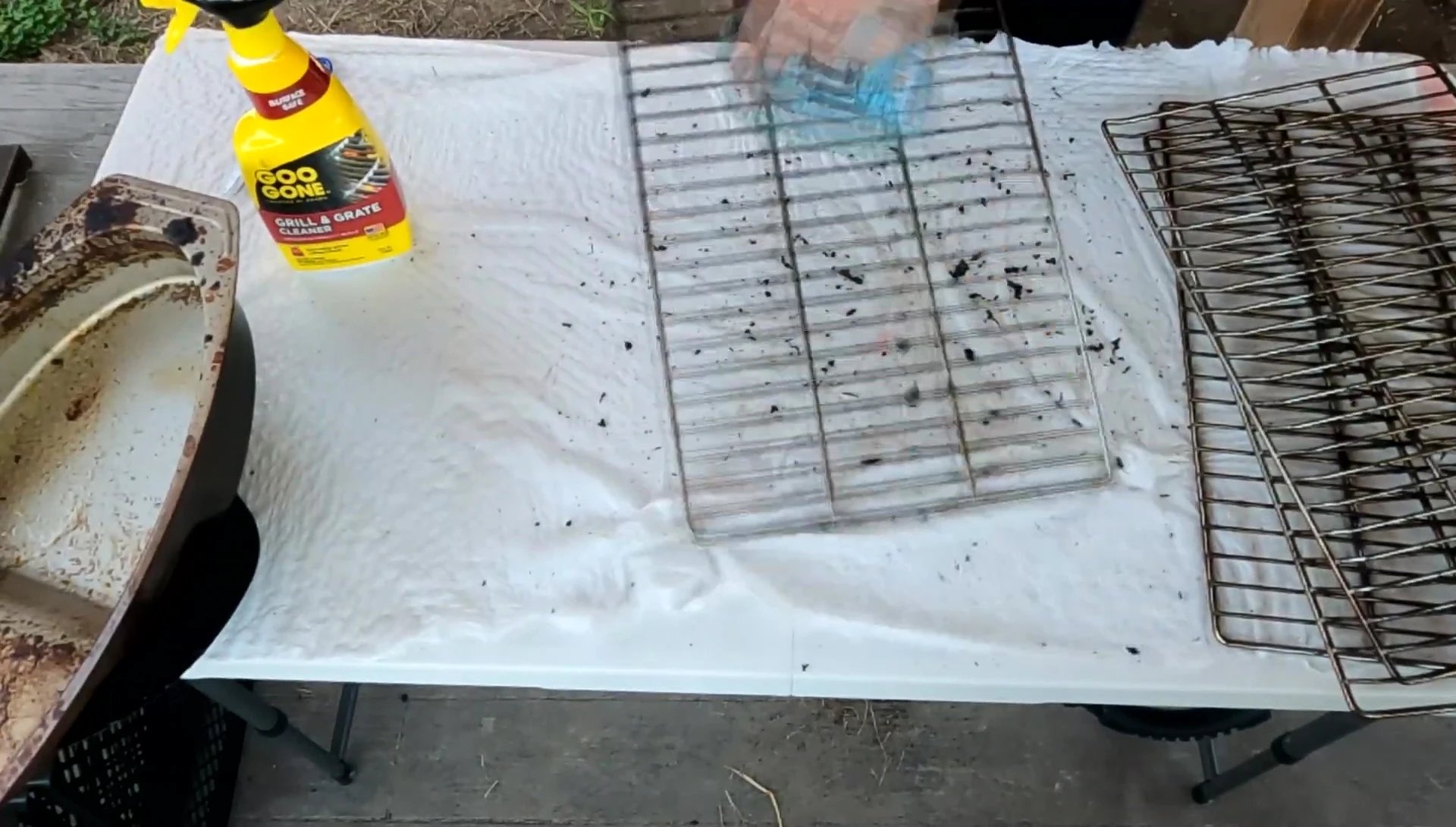 The reviewer brushing off the grates before applying the cleaner