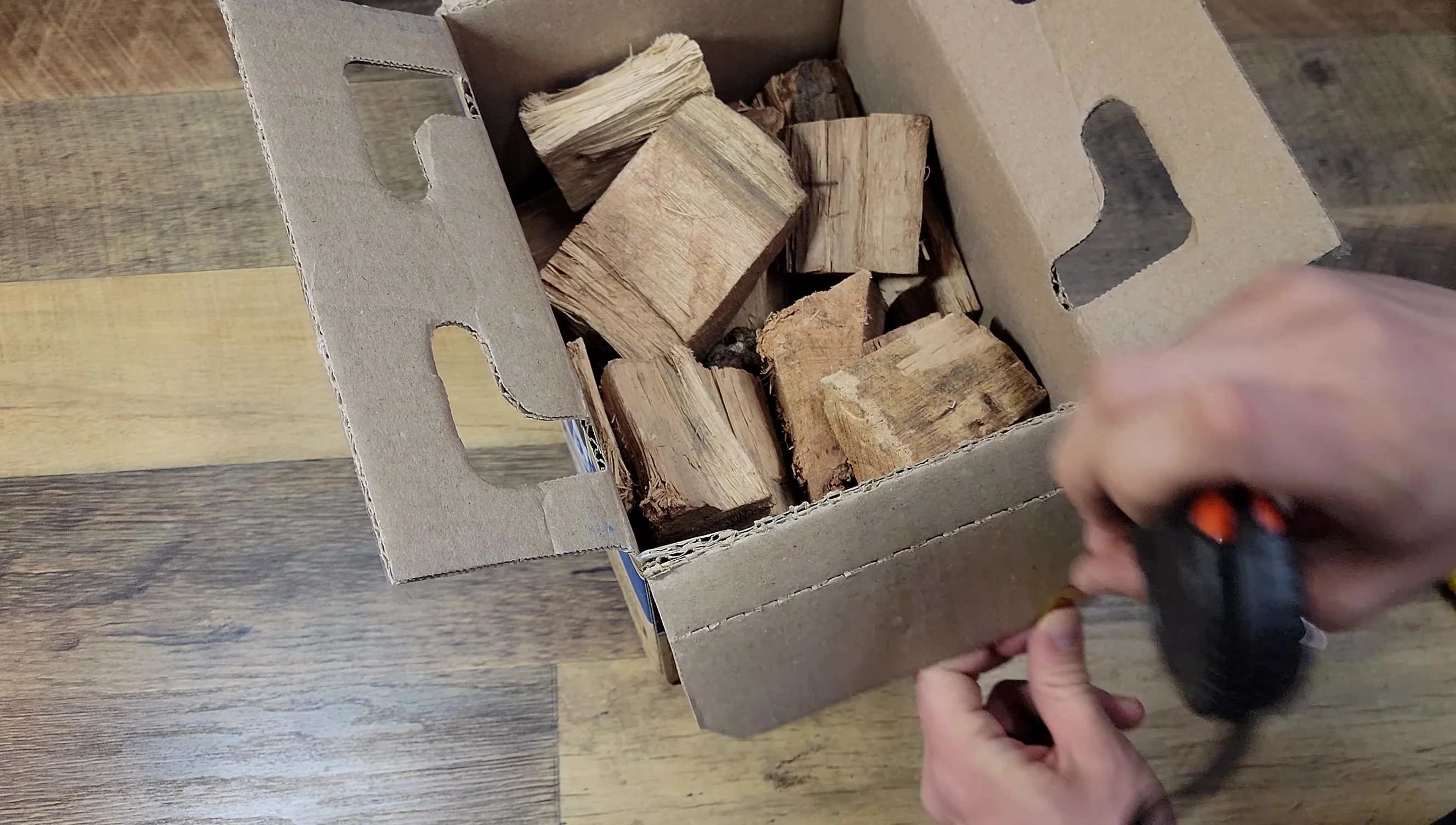 The reviewer showing the tape measure reading the box height.