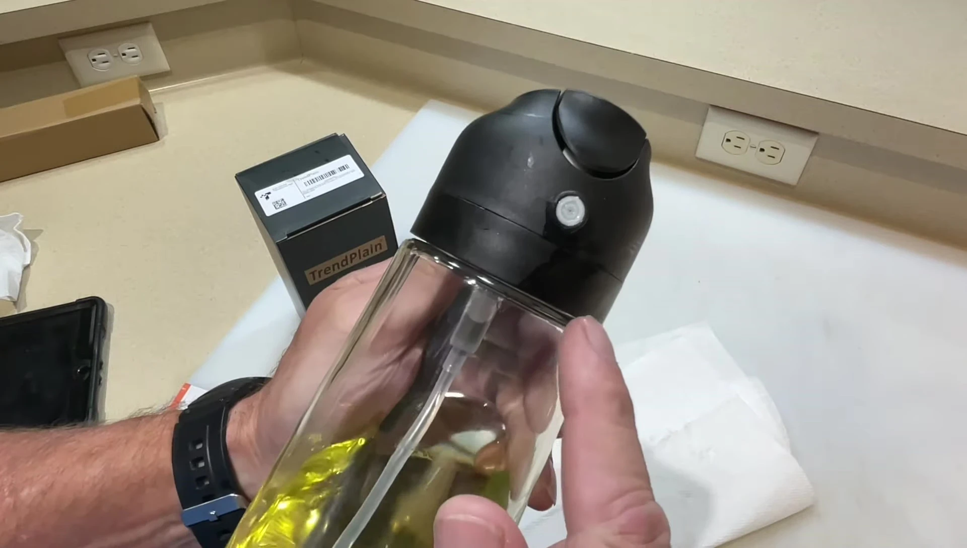 Close-up of the sprayer nozzle area showing minor leaking