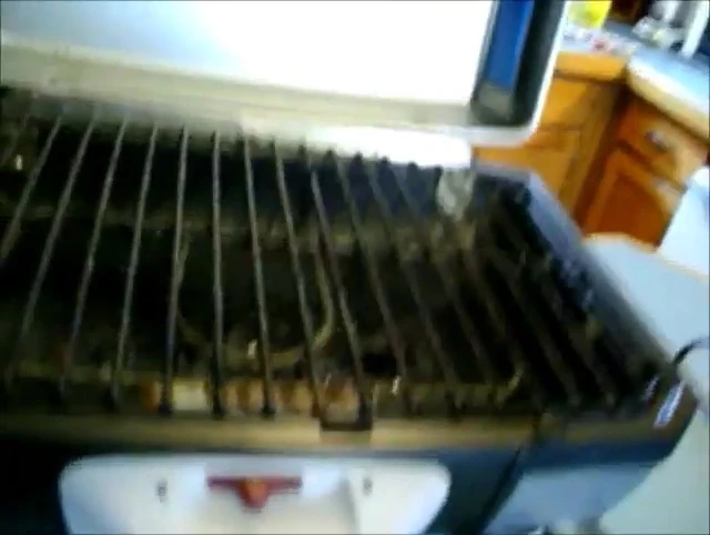 The inside of the grill after cooking, showing some residue.
