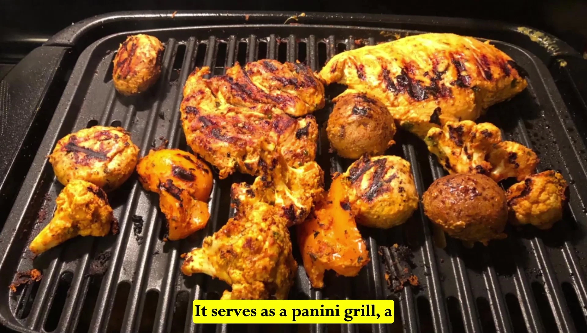 Close-up of the Elite Gourmet panini press open, showcasing its versatility.