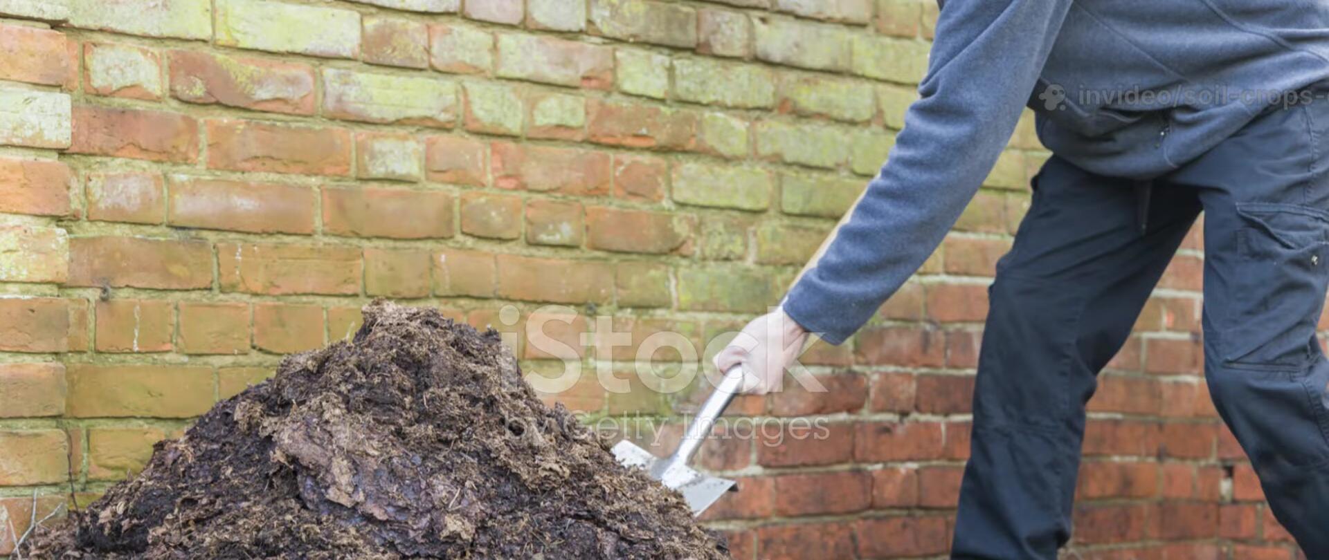 Person turning the compost pile