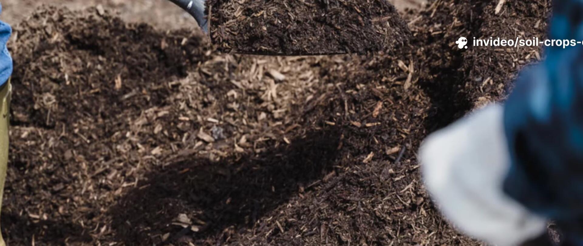 A person mixing compost ingredients