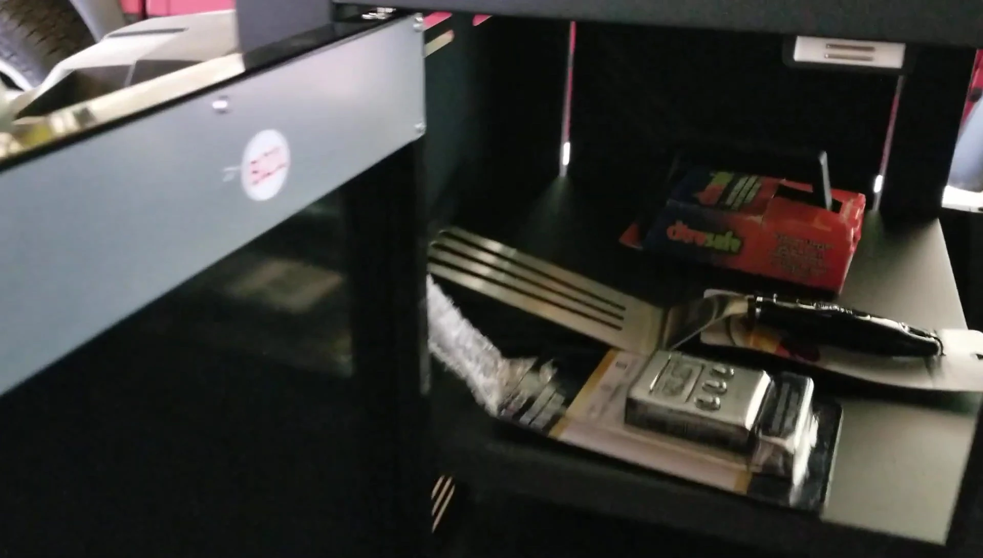 Showcase of the grill's storage compartment and thermometer probe holder