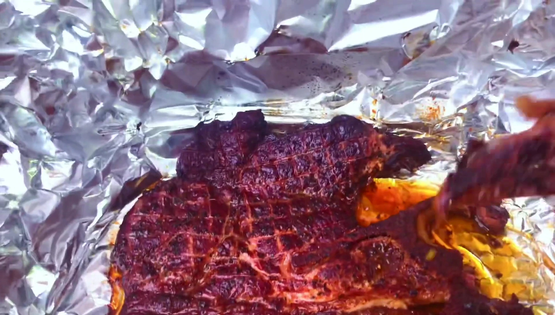 The reviewer takes a bite of the pork steak.