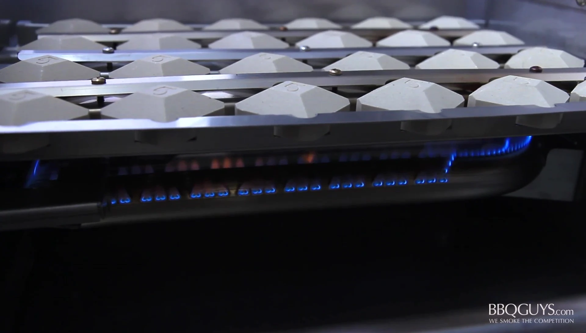 The stainless steel conventional burners beneath the briquette trays